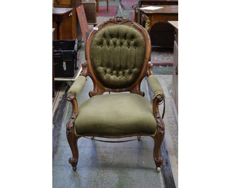 A Victorian walnut spoon back armchair, outswept arms, stuffed over upholstery, carved throughout with acanthus scrolls, cabr