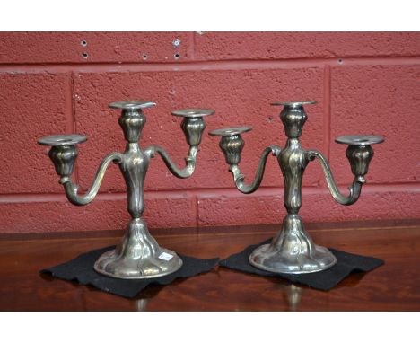 A pair of WMF Art Nouveau three light candelabra, detachable nozzles, embossed overall with sinuous lines, 25.5cm high, monog