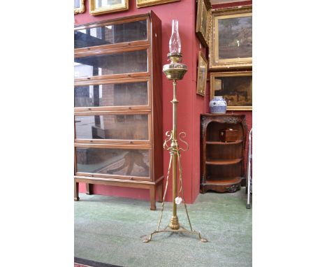 A decorative brass extending standard lamp
