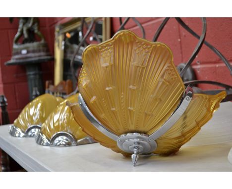 A Belgian retro lighting suite comprising a ceiling light and a pair of wall lights, circa 1950.