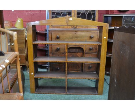 A golden oak Art Deco wall hanging bookshelf, architectural pediment, mahogany and satinwood marquetry to shelves. 