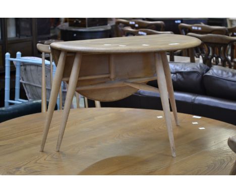 An Ercol drop leaf occasional table, circular top, single leaf, three turned legs.