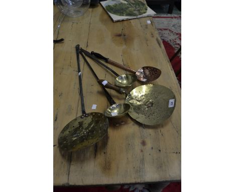 A George III brass and iron ladle; another;straining spoons; skimmers (5)