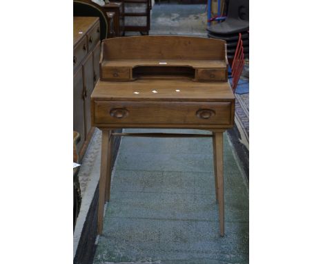 An Ercol lady's writing desk, galleried superstructure with drawers and recess, oversailing top, long drawer to frieze, sprea