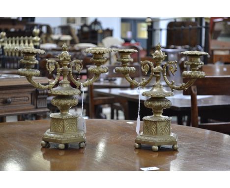 A pair of post-Regency gilt bronze two-light mantel candelabra, compressed campana sconces, detachable nozzles, hexagonal bas