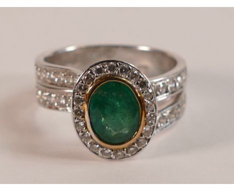 18ct white Gold Emerald and Diamond ring, centre oval emerald approx 8mm surrounded by diamonds with further diamonds setting