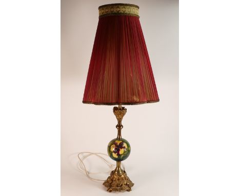 Moorcroft Hibiscus on green ground lamp of unusual form with globular ceramic centre. Ormolu brass floral mounts above and be