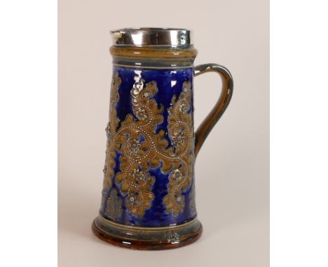 George Tinworth for Doulton Lambeth, silver mounted Saltglaze Stoneware jug. Dated 1879. Height: 24.5cm, Also signed Emma Mar