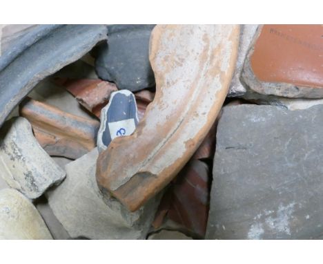 A collection of ancient pottery fragments and shards including one with handwritten locations within Roman Britain including 