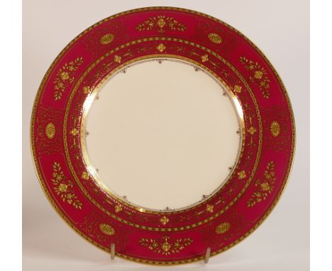 Mintons, heavily gilt Maroon ground cabinet plate. Raised gilt border in Regency style patterns. Diameter: 27cm