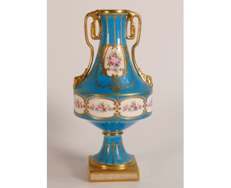Mintons two handled gilded vase, decorated with hand painted panels of roses, on light blue ground, h.20cm.