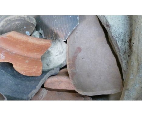 A collection of ancient pottery fragments and shards including several examples with handwritten locations within Roman Brita