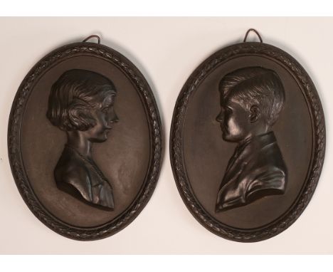 A pair of Wedgwood black Basalt oval portrait plaques, H.R.H The Earl of Macduff and Virginia Daughter of Mrs John Gilliat, 1