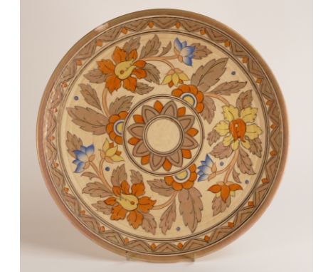 A Charlotte Rhead charger with Autumnal floral patterns with gilt highlights. Backstamp to rear for Crown Ducal. Diameter: 36