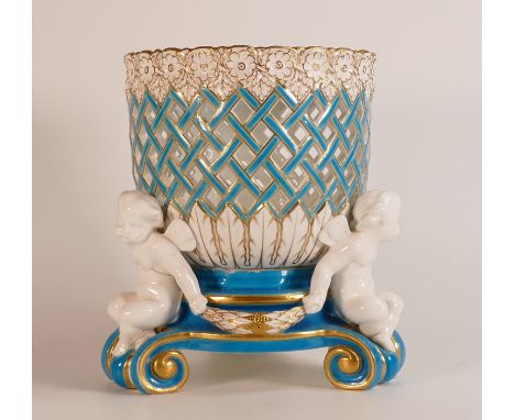 Mintons gilt decorated figural centre piece, c1875, with open latticework bowl, supported by three winged putti, h.22 x d.18c