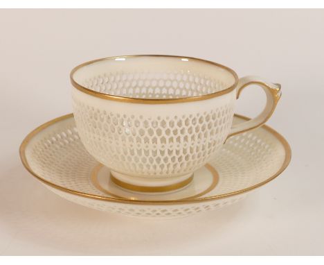 George Owen for Royal Worcester, a reticulated porcelain tea cup and saucer. Debossed mark to saucer and green printed backst
