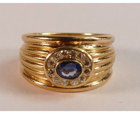 18ct Gold ring set with centre oval Sapphire surrounded by Diamonds, size P, 9.9g.