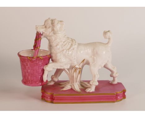 William Brownfield figure of dog with basket, c1875, in white and pink colours with gilt highlights, h.12.5 x L.16cm.