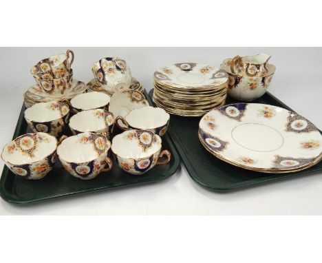 An early 20thC tea service, decorated with sprays of flowers within blue and gilt borders.