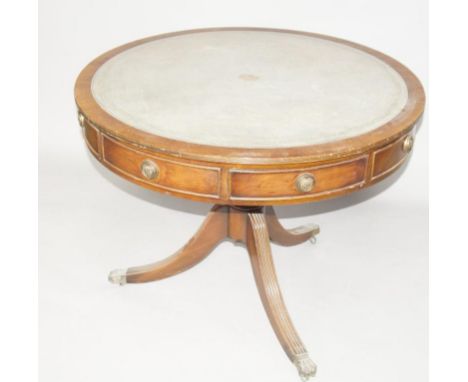 A reproduction mahogany Regency style drum head table, with circular inset leather top, on a turned column and reeded legs, r