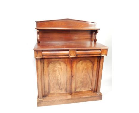 An early Victorian mahogany chiffonier, with formal arched gallery back fitted a shelf on two scroll  supports and with two f