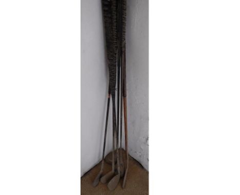 A hickory shafted golf putter, and five other vintage golf clubs.