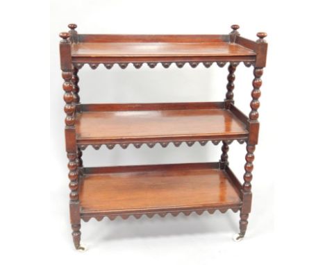 A Victorian mahogany three galleried tiered buffet, with bobbin turned supports upon ceramic castors, 90cm wide.