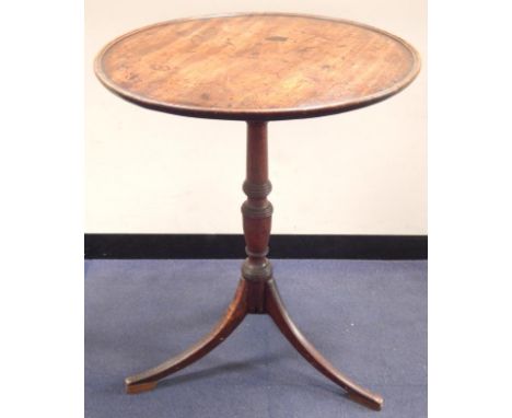 A 18thC mahogany circular tripod table, with moulded border and supported on a slender turned baluster column and with plain 
