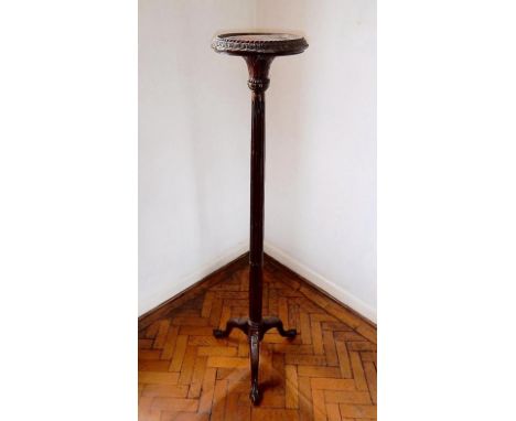 A mahogany torchere with circular platform and tripod base. 162cm high.