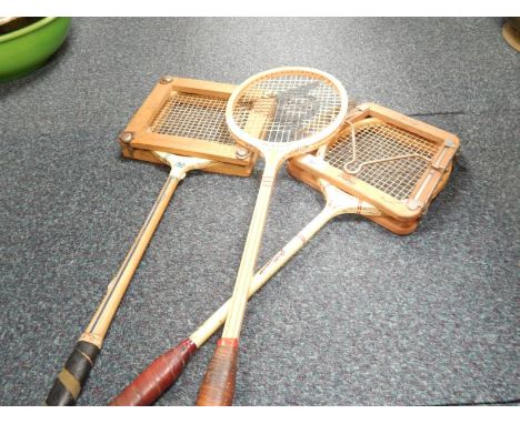 Three vintage badminton racquets.