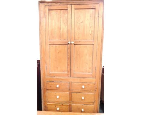 A Victorian pine kitchen larder, comprising twin panelled door top cupboard section, above two banks of three short drawers w