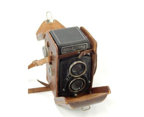 A Rolleicord twin lens reflex camera, with Compur lens in leather ever ready case.