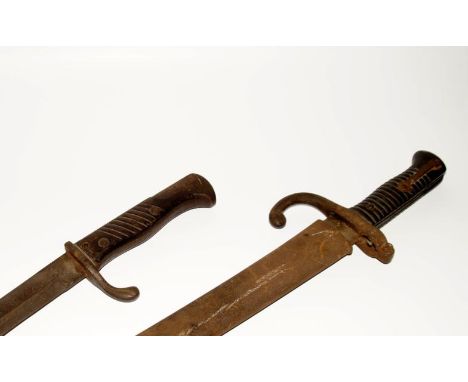 Two late 19thC/early 20thC bayonets, one with scabbard and bronzed handle, the other with a sized wooden handle.