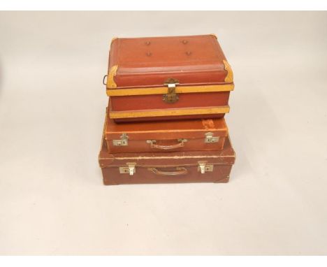A tin trunk and two suitcases.
