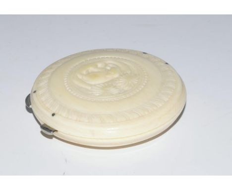A 1930's carved ivory powder compact.