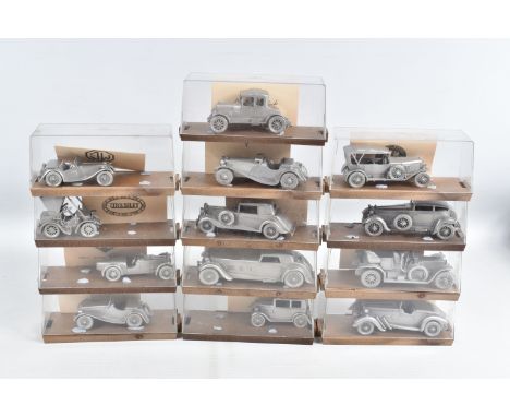 A COLLECTION OF DANBURY MINT WHITE METAL MODEL CARS IN DISPLAY CASES, to include, each with its own description card,  a 1936
