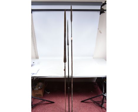 THREE TRIBAL HUNTING SPEARS, the first features a wooden shaft and a grooved arrow shaped steel tip, the overall length appro