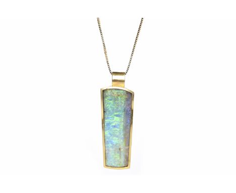 IMPRESSIVE OPAL PENDANTset with a large tapered section of opal 30x12mm in an eighteen carat gold mount, on an eighteen carat