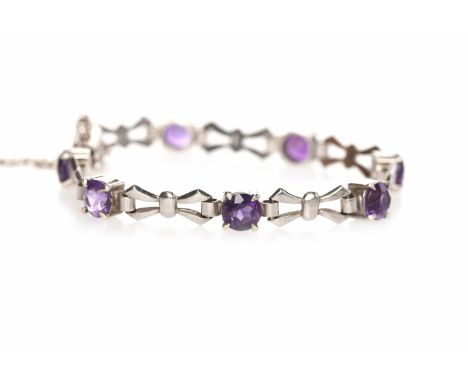 MID TWENTIETH CENTURY NINE CARAT WHITE GOLD AMETHYST SET BRACELETset with round amethysts interspaced by bow motif sections o