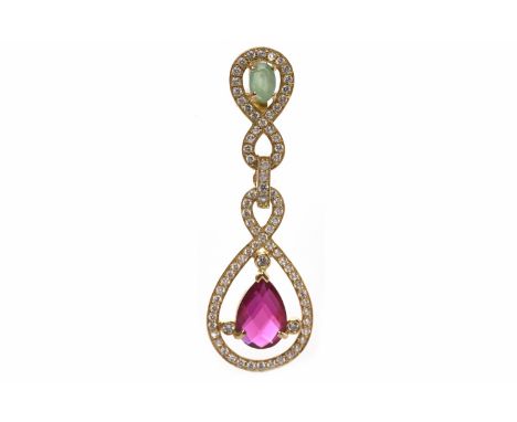 CREATED RUBY, EMERALD AND WHITE GEM SET PENDANTof open form, with a white gem set drop set with a central pear shaped created