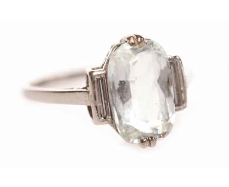 ART DECO PLATINUM AQUAMARINE AND DIAMOND RINGthe central oval aquamarine 11.3mm long and flanked by two baguette cut diamonds
