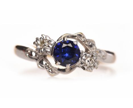 SAPPHIRE AND DIAMOND THREE STONE RINGthe central round sapphire 4.9mm diameter and flanked by illusion set diamonds totalling