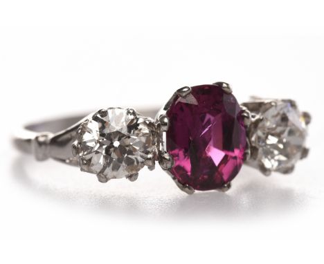 DIAMOND AND RUBY THREE STONE RINGset with a central oval ruby of approximately 1.19 carats flanked by two round brilliant cut