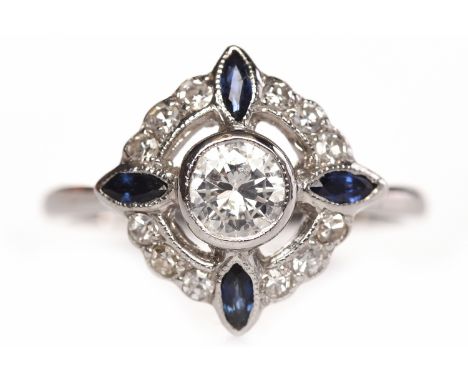 EARLY TWENTIETH CENTURY DIAMOND AND SAPPHIRE DRESS RINGthe pierced round bezel 14mm and set with a central round brilliant cu