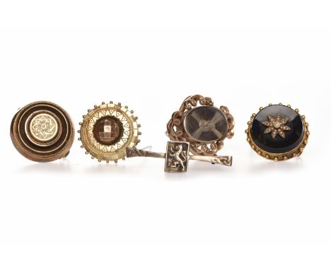 GROUP OF VICTORIAN BROOCHEScomprising two large examples, an onyx and pearl brooch, a hairwork example and a Scottish bar bro