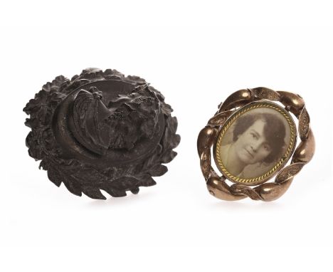 TWO VICTORIAN BROOCHEScomprising one carved jet example, of oval form and depicting a female in profile facing left, 55mm hig