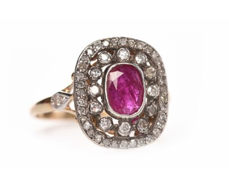 VICTORIAN STYLE RUBY AND DIAMOND RINGthe pierced rounded rectangular bezel 15mm long set with a central oval ruby 6.7mm long 