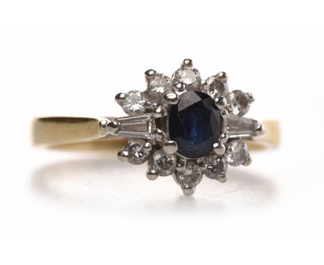 EIGHTEEN CARAT GOLD SAPPHIRE AND DIAMOND CLUSTER RINGset with with a central oval sapphire of approximately 0.42 carats surro