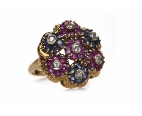 MID TWENTIETH CENTURY EIGHTEEN CARAT GOLD RUBY AND SAPPHIRE DRESS RINGthe round pierced bezel 20mm and set with round sapphir