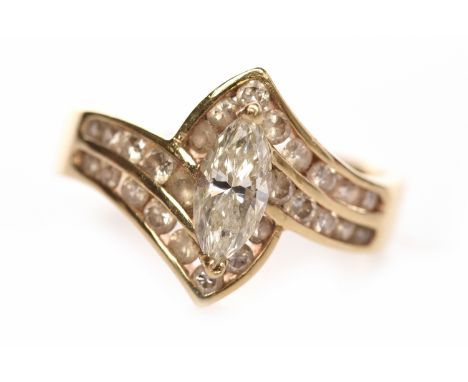 EIGHTEEN CARAT GOLD DIAMOND DRESS RINGset with a principal marquise cut diamond of approximately 0.40 carats on crossover rou